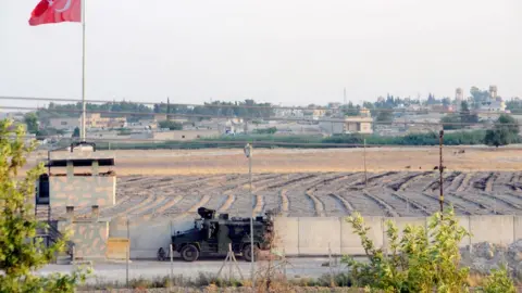 AFP Turkish troops patrol near the border with Syria, in Akcakale, in Sanliurfa, south-eastern Turkey (14 August 2019)