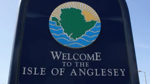 Sign 'Welcome to Isle of Anglesey' at Holyhead port