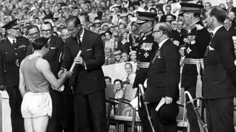 Getty Images Ken Jones hands Queen's Baton to Duke of Edinburgh at the opening of the Empire Games at Cardiff Arms Park in 1958