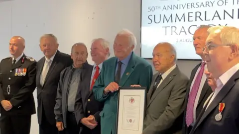 Chief fire officer with former firefighters