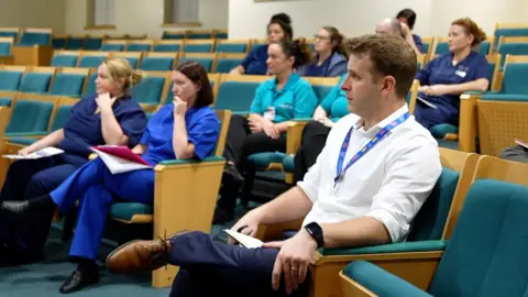 Staff at morning meeting