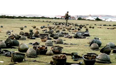 PA Media Discarded helmets on the ground in Falklands