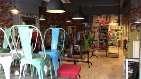 The Scullery Cafe Chairs stacked on tables in an empty cafe