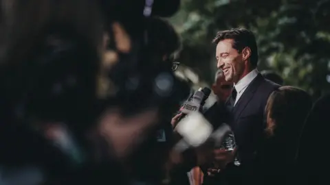 Brian de Rivera Simon/WireImage Hugh Jackman talks to the press outside the premiere of The Front Runner