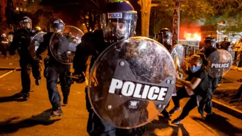 Police holding a riot shield