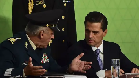 Getty Images President Enrique Pena Nieto (R) speaks with General Salvador Cienfuegos during a ceremony in Mexico City, on July 21, 2015