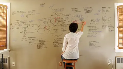 BBC Jen writes diagrams on a whiteboard