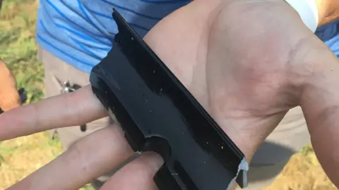 @wastatepatrol Washington State police officer holding obscure car part