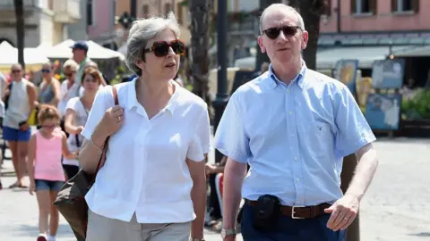 AFP Theresa May and her husband Philip in Italy