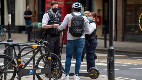 Getty Images Met police stop man on scooter