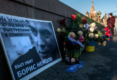 Getty Images Floral tributes at the site where opposition leader Boris Nemtsov was fatally shot on a bridge near the Kremlin, in Moscow, pictured on 10 January, 2018.