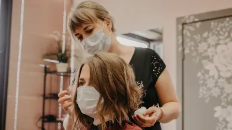 Getty Images Hairdresser with client