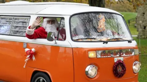 Andrew Matthews/PA Wire Santa in campervan