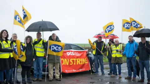 Getty Images PCS union members on strike at Cardiff airport