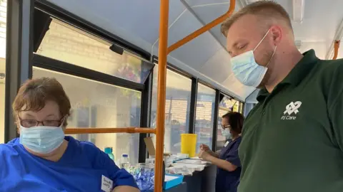 PJ Care care worker about to be vaccinated