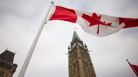 AFP/Getty A Canadian flag flies in front of the peace tower on Parliament Hill in Ottawa, Canada on December 4, 2015