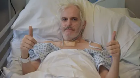 Mid and South Essex NHS Foundation Trust Stuart Oakley in his hospital bed