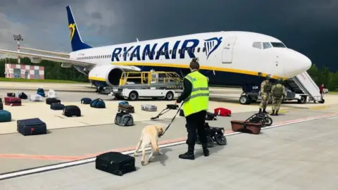 EPA Sniffer dog checks bags taken off Ryanair flight at Minsk