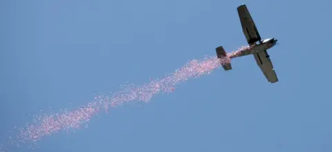 EPA Poppies are released by plane during a Remembrance Day ceremony in Adelaide, Australia, 11 November 2018