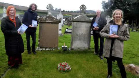 Rosemary Henderson Rosemary and members of her family at Molly's graveside in St Finlough's church