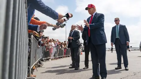 Getty Images Former President Donald Trump speaks to the media as he arrives at the Atlanta Airport on April 10, 2024 in Atlanta, Georgia. Trump is visiting Atlanta for a campaign fundraising event he is hosting