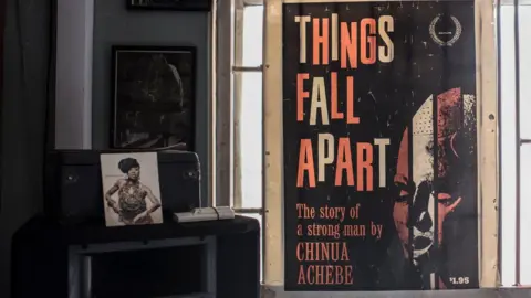 AFP A poster for Things Fall Apart in the Jazz Hole bookshop in Lagos, Nigeria