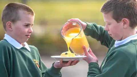 Schoolboys with dessert