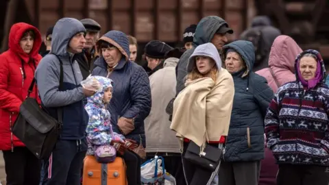 Getty Images Families wait to board a train at Kramatorsk central station in the Donbass region of Ukraine on 5 April 2022.