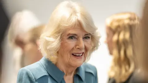 Daily Telegraph/ PA A close up of Queen Camilla smiles during her visit to London's Royal Free Hospital