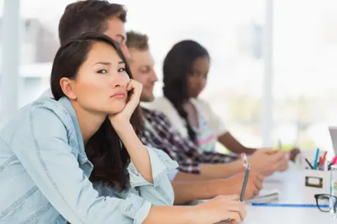 Getty Images Bored woman in meeting