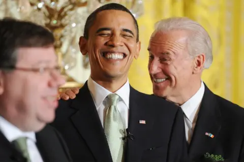 Michael Reynolds / Getty Images President Barack Obama and Vice President Joe Biden laugh together