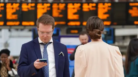 PA Media Rail passengers at a station