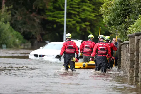 Shutterstock Emergency services attend a flooded street