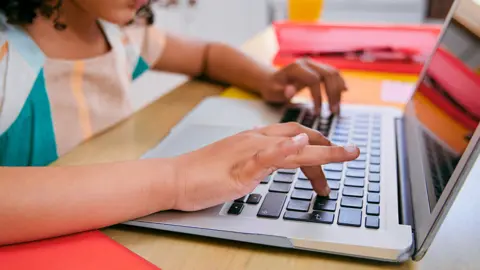 Getty Images Young child uses laptop