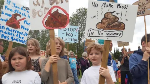 Caroline Keates Children with placards at a Procession Against Poo, in Bungay, Suffolk