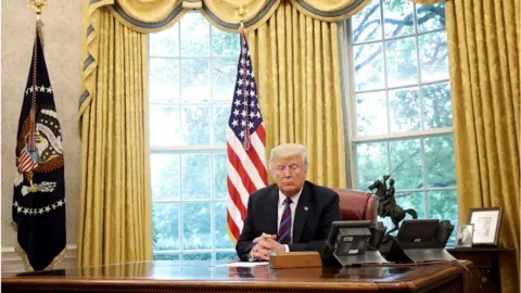 Getty Images President Donald Trump speaks on the telephone via speakerphone with Mexican President Enrique Pena Nieto in the Oval Office of the White House on August 27, 2018