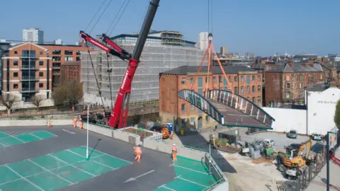 Leeds City Council David Oluwale Bridge being lowered into position in Leeds