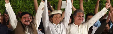 AFP Chairman of Pakistan's Tehreek-e-Insaf (PTI) party, Imran Khan (centre), greets the audience during a rally on 14 August 2017