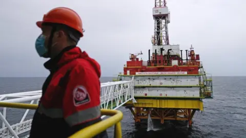 Reuters An employee is seen at an oil platform operated by Lukoil company at the Kravtsovskoye oilfield in the Baltic Sea, Russia