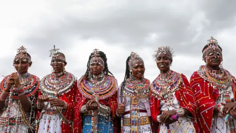 EPA Maasai women wear their traditional attire to watch the games play out