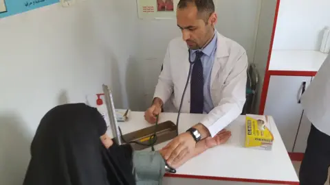 Laith Al-Rubaiy Dr Laith Al-Rubaiy assessing a patient in Iraq