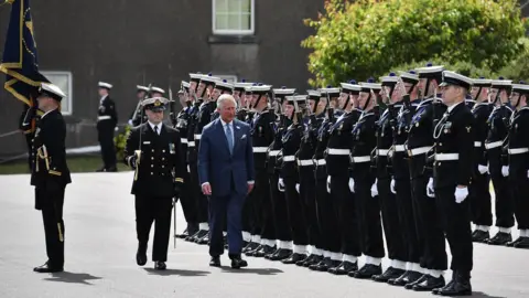 Charles McQuillan Prince of Wales inspects an honour guard during visit to Cork Naval Base
