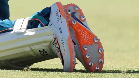 Getty Images Usman Khawaja's shoes which say "All lives are equal"