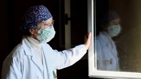 Reuters Laura Ricevuti, the medical doctor who diagnosed the first case of COVID-19 in an Italian patient with Dr. Malara on February 20, looks through the window at Codogno Hospital