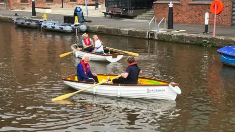 people on boats in Gloucester Docks