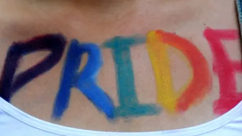 Getty Images A woman takes part in Turkey's Gay Pride parade with the word 'Pride' painted on her body (file picture)