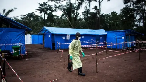 AFP A health worker walks at an Ebola quarantine unit in the DR Congo