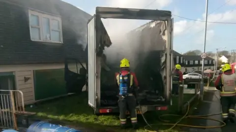 www.movecorp.co.uk Fire officers dousing van