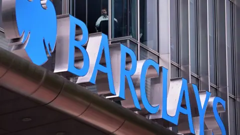 Getty Images Man looks out of Barclays office