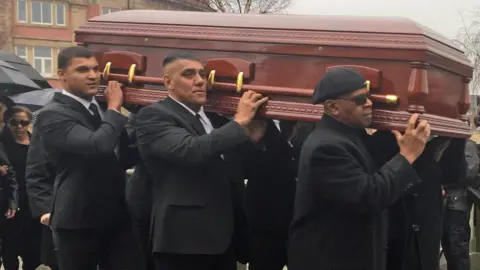 PA Eddy Amoo's coffin is carried in